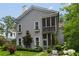Charming two-story home featuring a screened porch and well-maintained landscaping with flower boxes at 9032 Selborne Ln, Chattahoochee Hills, GA 30268