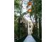 Scenic footbridge with hanging lanterns in Serenbe at 9032 Selborne Ln, Chattahoochee Hills, GA 30268