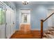 Bright foyer with hardwood floors, staircase, and access to other rooms at 9032 Selborne Ln, Chattahoochee Hills, GA 30268