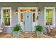 Inviting light blue front door with white trim and potted plants at 9032 Selborne Ln, Chattahoochee Hills, GA 30268