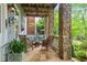 Relaxing stone patio with wicker seating and lush greenery at 9032 Selborne Ln, Chattahoochee Hills, GA 30268