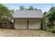 Two-car garage with white doors and gray roof at 9032 Selborne Ln, Chattahoochee Hills, GA 30268