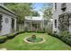 Landscaped courtyard with circular garden and stone path at 9032 Selborne Ln, Chattahoochee Hills, GA 30268