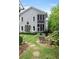 Gray house with screened porch and landscaped backyard at 9032 Selborne Ln, Chattahoochee Hills, GA 30268