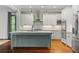 Bright kitchen with white cabinetry, marble countertops, stainless steel appliances and hardwood flooring at 9032 Selborne Ln, Chattahoochee Hills, GA 30268