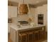 Modern kitchen boasts a gray island, white cabinets, marble countertops, and stainless steel appliances at 9032 Selborne Ln, Chattahoochee Hills, GA 30268