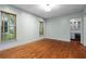Spacious living room with hardwood floors, ample lighting, and view into butler's pantry at 9032 Selborne Ln, Chattahoochee Hills, GA 30268