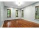Bright room featuring hardwood floors, natural light, and plenty of space at 9032 Selborne Ln, Chattahoochee Hills, GA 30268