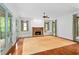 Bright living room featuring fireplace, large windows, and French doors to the porch at 9032 Selborne Ln, Chattahoochee Hills, GA 30268