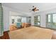 Open living space flows into kitchen with island and screened porch, offering seamless indoor-outdoor living at 9032 Selborne Ln, Chattahoochee Hills, GA 30268