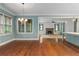 Open-concept space with hardwood floors, fireplace and seamlessly connected living spaces at 9032 Selborne Ln, Chattahoochee Hills, GA 30268