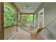 Relaxing screened porch with hammock overlooking lush greenery at 9032 Selborne Ln, Chattahoochee Hills, GA 30268