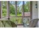 Serene screened porch offering wooded backyard views at 9032 Selborne Ln, Chattahoochee Hills, GA 30268