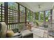 Relaxing screened porch with wicker furniture and wooded views at 9032 Selborne Ln, Chattahoochee Hills, GA 30268