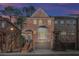 Brick front exterior of townhome with 2-car garage and steps at dusk at 2480 Magnolia Ridge Se Dr, Marietta, GA 30067