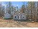 Gray guest house with a small deck in wooded setting at 900 Cass Pine Log Rd, Rydal, GA 30171