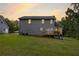 Gray house exterior, deck, and surrounding yard at dusk at 900 Cass Pine Log Rd, Rydal, GA 30171