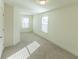 Well-lit bedroom with carpeted floor and two windows at 1884 Plainsboro Dr, Lithonia, GA 30058