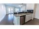 Modern kitchen with granite countertops, stainless steel appliances, and breakfast bar at 1884 Plainsboro Dr, Lithonia, GA 30058