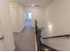 Upstairs hallway with carpet and access to bedrooms at 1884 Plainsboro Dr, Lithonia, GA 30058