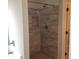 Walk-in shower with beige marble-like tiles at 252 Magnaview Dr, Mcdonough, GA 30253