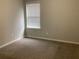 Empty carpeted bedroom with a window and blinds at 252 Magnaview Dr, Mcdonough, GA 30253