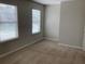 Bright bedroom with two windows and carpet at 252 Magnaview Dr, Mcdonough, GA 30253