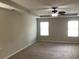 Carpeted bedroom with ceiling fan and two windows at 252 Magnaview Dr, Mcdonough, GA 30253