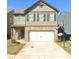 Two-story house with a white garage door and basketball hoop at 252 Magnaview Dr, Mcdonough, GA 30253