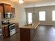 Kitchen with island, stainless steel appliances, and wood cabinets at 252 Magnaview Dr, Mcdonough, GA 30253