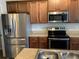 Stainless steel appliances and wood cabinets in kitchen at 252 Magnaview Dr, Mcdonough, GA 30253