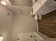 Clean bathroom with wood-look floors and a tub shower at 258 Pickett Bridge Rd, Covington, GA 30016