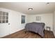 Simple bedroom with a double bed, wood floors, and white walls at 679 Montevista St, Atlanta, GA 30310