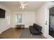 Cozy bedroom with a sofa bed, wood floors, and a large window at 679 Montevista St, Atlanta, GA 30310