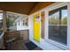 Bright yellow door entry with wooden railings and a small table at 679 Montevista St, Atlanta, GA 30310