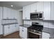 Modern kitchen with stainless steel appliances and white cabinets at 679 Montevista St, Atlanta, GA 30310