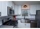 Modern kitchen with stainless steel appliances and a corner sink at 679 Montevista St, Atlanta, GA 30310