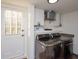 Bright laundry room, featuring washer, dryer, and built-in cabinets at 679 Montevista St, Atlanta, GA 30310