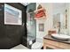 Modern bathroom with dark tile and floating shelves at 824 Amsterdam Ne Ave, Atlanta, GA 30306