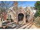 Brick home exterior with arched entryway and well-maintained landscaping at 824 Amsterdam Ne Ave, Atlanta, GA 30306