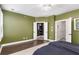 Green bedroom with walk-in closet and hardwood floors at 207 Mitchell Ln, Woodstock, GA 30188