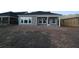 Exterior view of the house with multiple windows looking onto the green backyard at 2036 Ripple Park Bnd, Canton, GA 30114