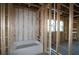 Framed bathroom with tub installed and plumbing in progress at 2036 Ripple Park Bnd, Canton, GA 30114