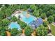 Aerial view of the community pool and waterpark, surrounded by lush trees at 2036 Ripple Park Bnd, Canton, GA 30114