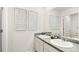 Bathroom with double vanity, gray countertop and decorative wall art at 279 Friendship Oak Way, Hampton, GA 30228