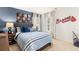 Baseball-themed bedroom with a striped comforter and desk at 279 Friendship Oak Way, Hampton, GA 30228