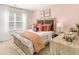 Bedroom with a king-size bed and light pink walls at 279 Friendship Oak Way, Hampton, GA 30228