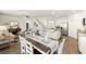 Open concept dining area with hardwood floors and white chairs at 279 Friendship Oak Way, Hampton, GA 30228