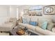 Light and airy living room features a neutral colored couch and cozy seating at 279 Friendship Oak Way, Hampton, GA 30228