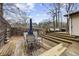 Multi-tiered back deck with several seating areas under the shade of trees at 883 Verona Dr, Clarkston, GA 30021